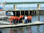Sea Cadets line up on the dock, prior to jumping into 58� water with Survival Suits. Photo by CWO F. Woodward, NSCC